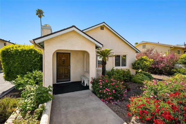 243 N 11th St, Grover Beach, CA 93433 - view of front of property featuring a chimney and stucco siding