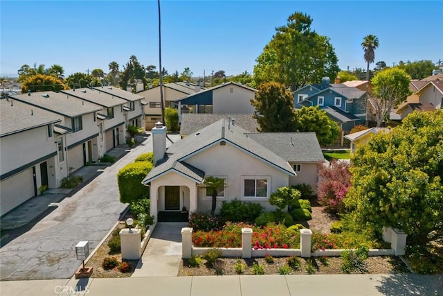 243 N 11th St, Grover Beach, CA 93433 - view of front of house with a residential view, stucco siding, and a chimney