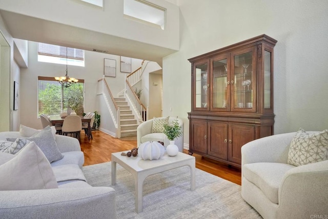 11983 Mountain Pass Rd, San Diego, CA 92128 - living area featuring a chandelier, stairs, wood finished floors, and a high ceiling