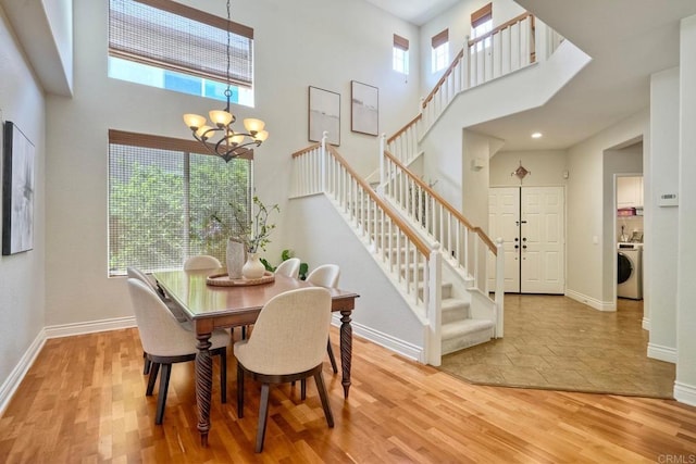 11983 Mountain Pass Rd, San Diego, CA 92128 - dining space with a high ceiling, stairs, a chandelier, and baseboards