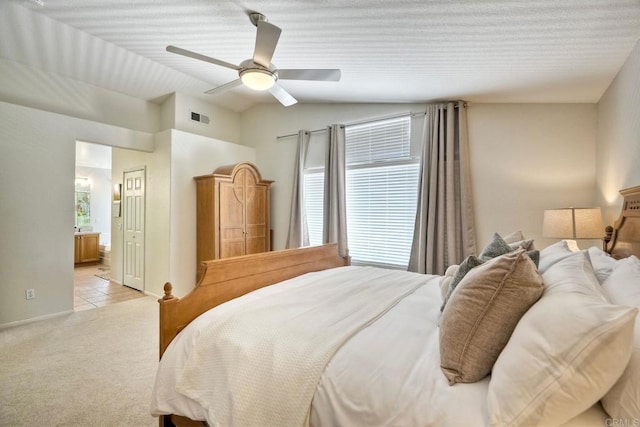 11983 Mountain Pass Rd, San Diego, CA 92128 - bedroom with light colored carpet, vaulted ceiling, connected bathroom, ceiling fan, and light tile patterned flooring