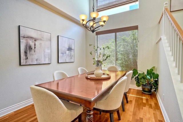 11983 Mountain Pass Rd, San Diego, CA 92128 - dining area with a chandelier, light wood-style flooring, stairs, and baseboards