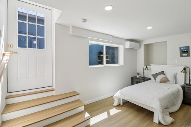 1740 Petra Dr, San Diego, CA 92104 - bedroom featuring a wall mounted AC, wood finished floors, baseboards, and recessed lighting