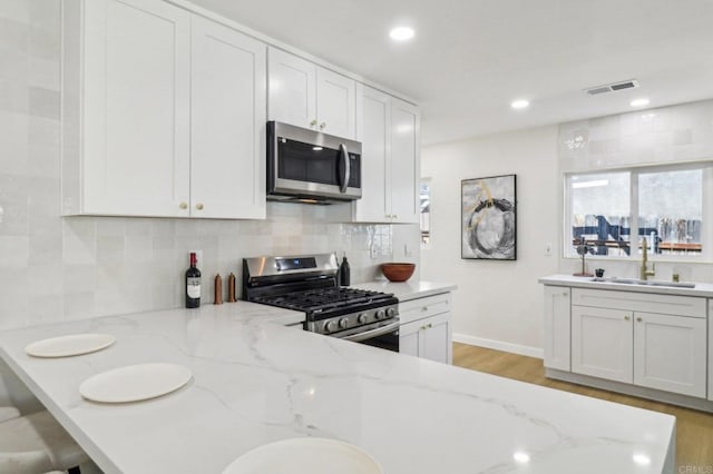 1740 Petra Dr, San Diego, CA 92104 - kitchen featuring stainless steel appliances, a sink, decorative backsplash, baseboards, and recessed lighting