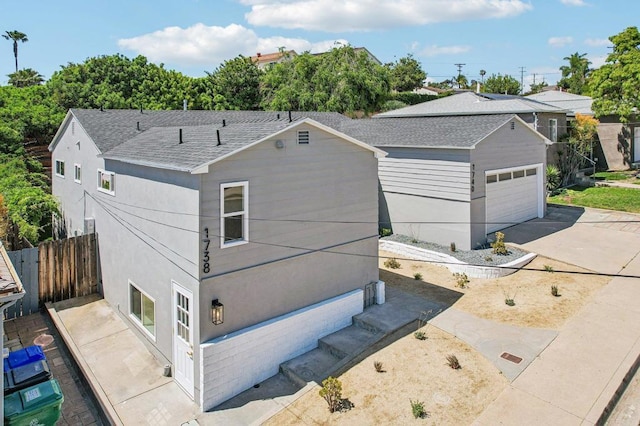 1740 Petra Dr, San Diego, CA 92104 - view of front facade with asphalt driveway, stucco siding, and a shingled roof