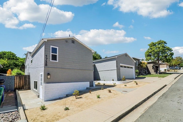 1740 Petra Dr, San Diego, CA 92104 - view of front facade with a detached garage and an outbuilding