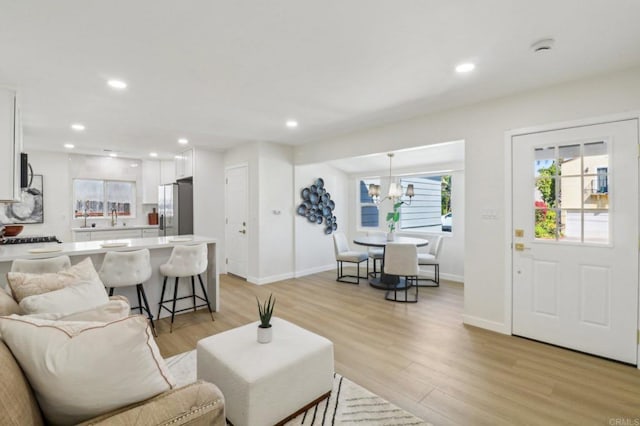 1740 Petra Dr, San Diego, CA 92104 - living room featuring light wood-style floors, baseboards, a chandelier, and recessed lighting