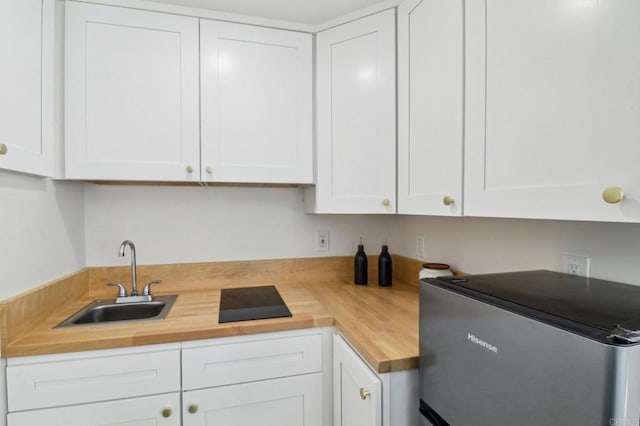 1740 Petra Dr, San Diego, CA 92104 - kitchen with refrigerator, butcher block countertops, a sink, and white cabinetry