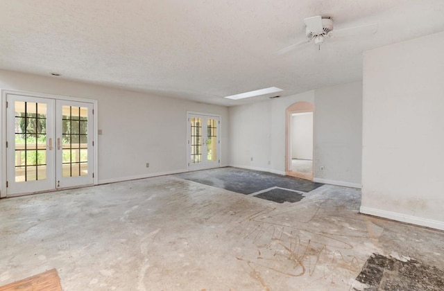 9182 Tonya Ln, Santee, CA 92071 - empty room with french doors, arched walkways, a textured ceiling, baseboards, and a ceiling fan