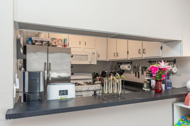 1772 Sinaloa Rd Unit 290, Simi Valley, CA 93065 - kitchen with white appliances, a peninsula, and dark countertops