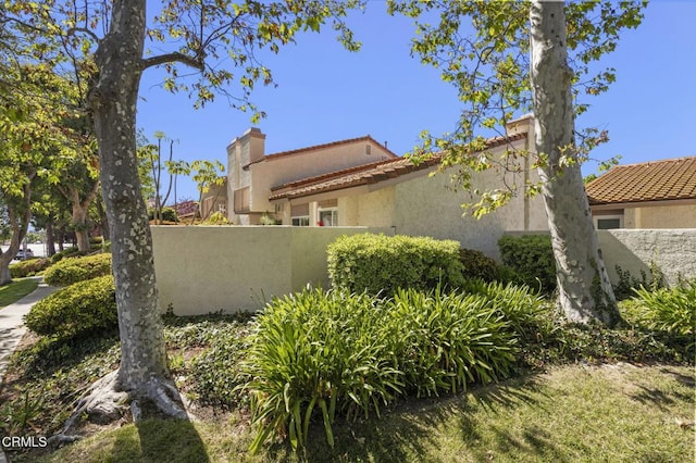 2036 Birchdale Ct, Thousand Oaks, CA 91362 - view of side of property featuring a tile roof, stucco siding, and a chimney
