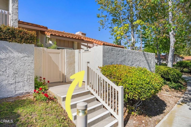 2036 Birchdale Ct, Thousand Oaks, CA 91362 - entrance to property with a gate, a tile roof, and stucco siding