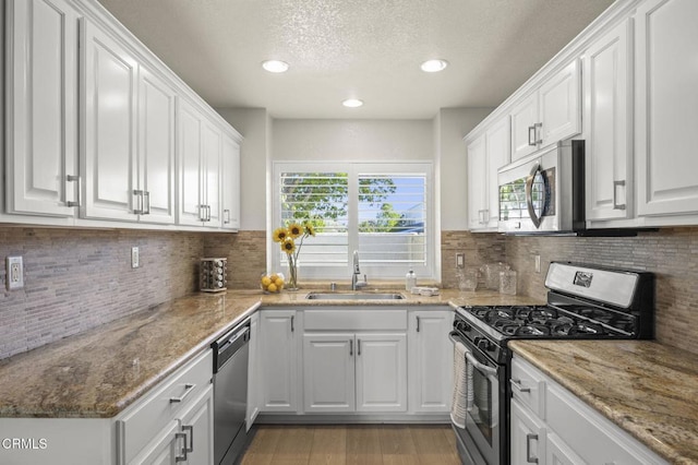 2036 Birchdale Ct, Thousand Oaks, CA 91362 - kitchen with appliances with stainless steel finishes, a sink, healthy amount of natural light, white cabinets, and a textured ceiling
