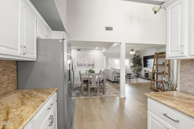 2036 Birchdale Ct, Thousand Oaks, CA 91362 - kitchen with stainless steel refrigerator with ice dispenser, a ceiling fan, white cabinetry, decorative backsplash, and light wood-style floors