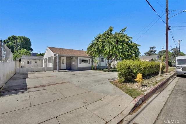 15330 Hart St, Van Nuys, CA 91406 - view of front facade with concrete driveway and a gate