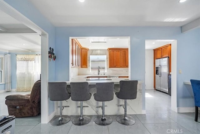 15330 Hart St, Van Nuys, CA 91406 - kitchen featuring stainless steel fridge, a kitchen bar, a peninsula, light countertops, and recessed lighting