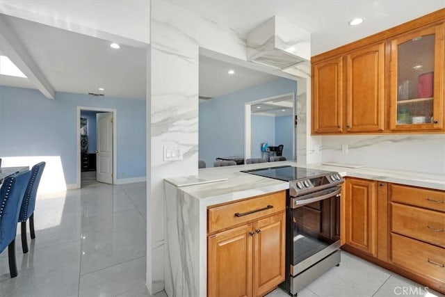 15330 Hart St, Van Nuys, CA 91406 - kitchen featuring stainless steel electric stove, glass insert cabinets, light countertops, brown cabinetry, and recessed lighting