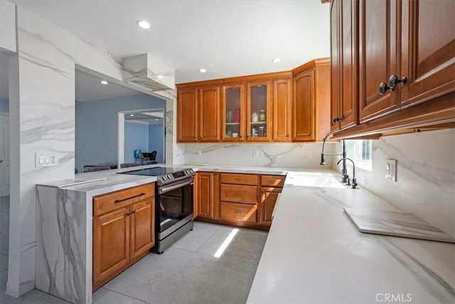 15330 Hart St, Van Nuys, CA 91406 - kitchen featuring electric stove, brown cabinets, glass insert cabinets, a sink, and recessed lighting