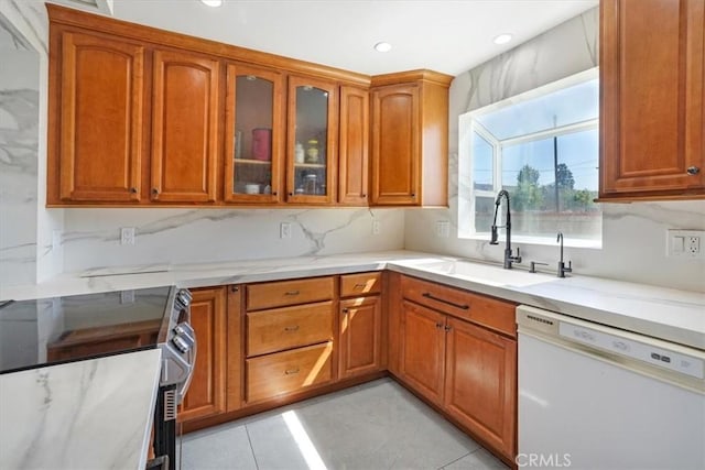 15330 Hart St, Van Nuys, CA 91406 - kitchen with white dishwasher, a sink, brown cabinets, stainless steel electric range oven, and glass insert cabinets
