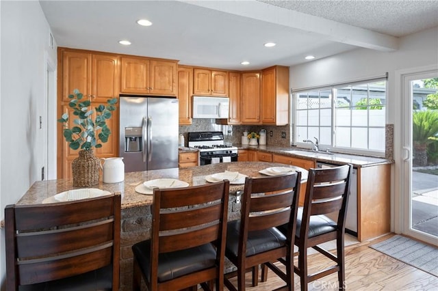 22792 La Quinta Dr, Mission Viejo, CA 92691 - kitchen with white appliances, a sink, recessed lighting, tasteful backsplash, and light stone counters