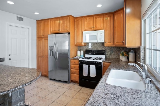 22792 La Quinta Dr, Mission Viejo, CA 92691 - kitchen featuring white microwave, stainless steel refrigerator with ice dispenser, gas range oven, a sink, and tasteful backsplash