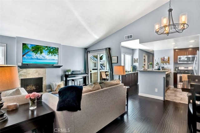 6223 Newhaven Ct, Yorba Linda, CA 92887 - living room with lofted ceiling, a chandelier, a fireplace, dark wood-style flooring, and baseboards