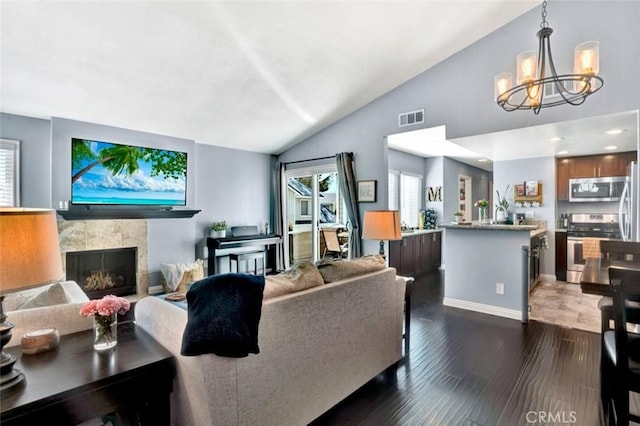 6223 Newhaven Ct, Yorba Linda, CA 92887 - living room featuring vaulted ceiling, a chandelier, a fireplace, dark wood finished floors, and baseboards
