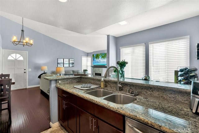 6223 Newhaven Ct, Yorba Linda, CA 92887 - kitchen with a sink, light stone countertops, lofted ceiling, baseboards, and a chandelier
