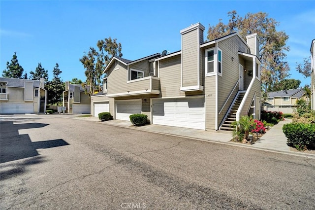 6223 Newhaven Ct, Yorba Linda, CA 92887 - view of home's exterior with an attached garage, stairway, a residential view, a chimney, and driveway
