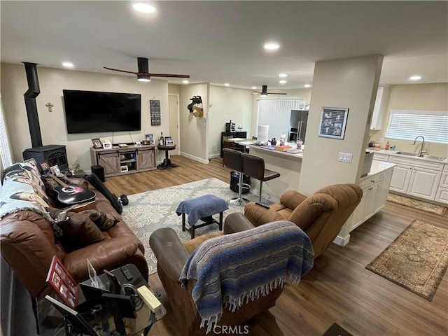 4313 Longview Ln, Paso Robles, CA 93446 - living area featuring ceiling fan, a wood stove, light wood-style floors, recessed lighting, and baseboards