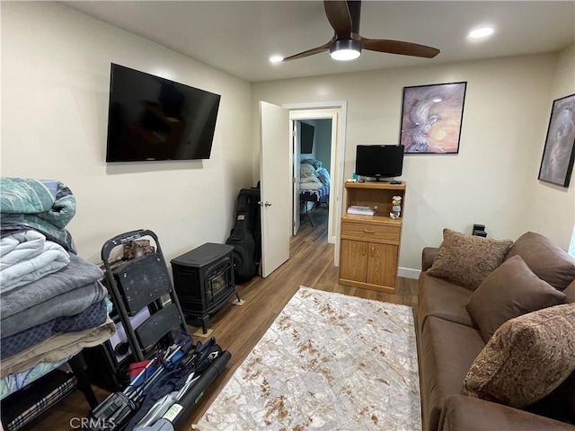 4313 Longview Ln, Paso Robles, CA 93446 - living room featuring a wood stove, a ceiling fan, wood finished floors, recessed lighting, and baseboards
