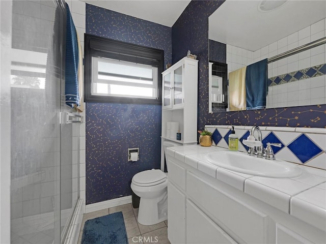933 E 1st St Unit 7, Long Beach, CA 90802 - full bathroom featuring a shower with shower door, vanity, toilet, wallpapered walls, and tile patterned floors
