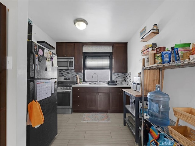 933 E 1st St Unit 7, Long Beach, CA 90802 - kitchen featuring appliances with stainless steel finishes, backsplash, light countertops, and a sink