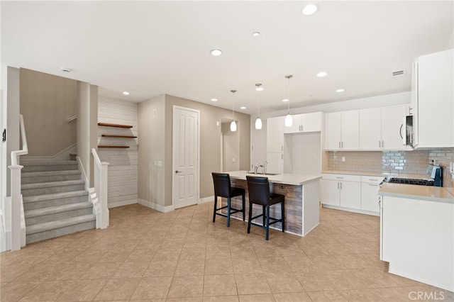 16 Fenix St, Rancho Mission Viejo, CA 92694 - kitchen with recessed lighting, an island with sink, light countertops, stainless steel microwave, and stove