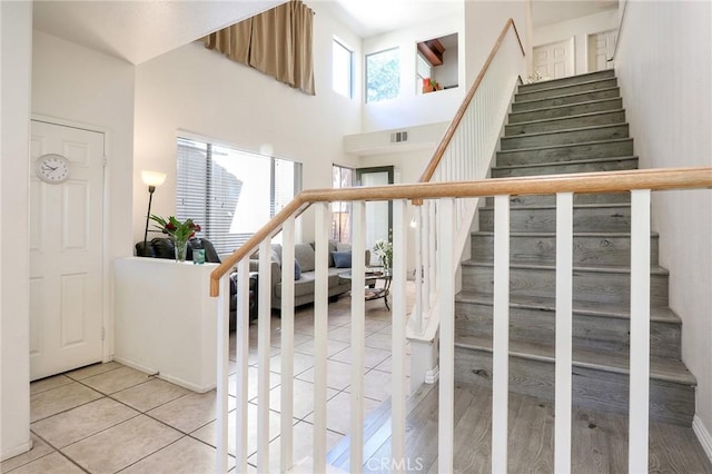 3738 Springmount St, Riverside, CA 92501 - stairs featuring tile patterned floors and a towering ceiling