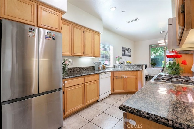 3738 Springmount St, Riverside, CA 92501 - kitchen with freestanding refrigerator, dishwasher, a sink, light tile patterned floors, and light brown cabinets