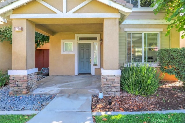 3738 Springmount St, Riverside, CA 92501 - doorway to property featuring stucco siding and stone siding