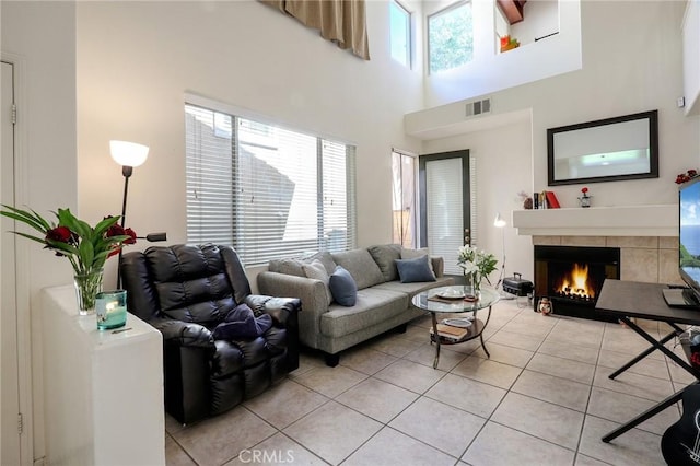3738 Springmount St, Riverside, CA 92501 - living room featuring light tile patterned floors, a tile fireplace, and a high ceiling