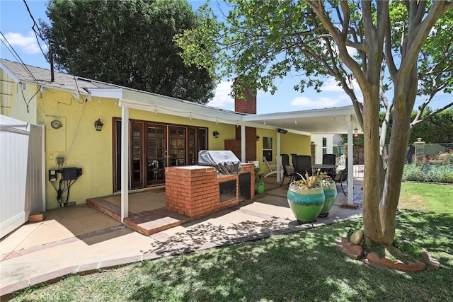 22941 Keswick St, West Hills, CA 91304 - back of property with a chimney, a patio, a yard, and stucco siding