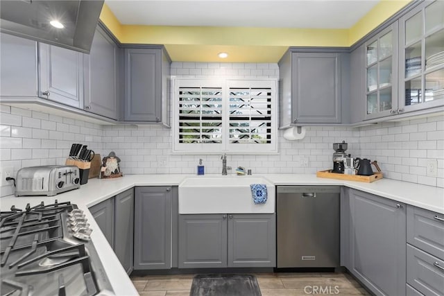 22941 Keswick St, West Hills, CA 91304 - kitchen with appliances with stainless steel finishes, gray cabinets, a sink, and wall chimney range hood