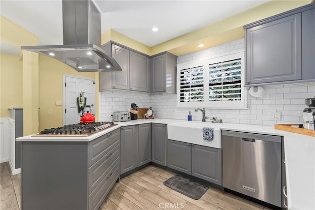 22941 Keswick St, West Hills, CA 91304 - kitchen with gray cabinets, appliances with stainless steel finishes, island exhaust hood, a sink, and light wood-style flooring