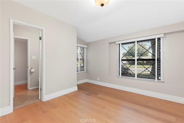 22941 Keswick St, West Hills, CA 91304 - spare room with plenty of natural light, light wood finished floors, vaulted ceiling, and baseboards