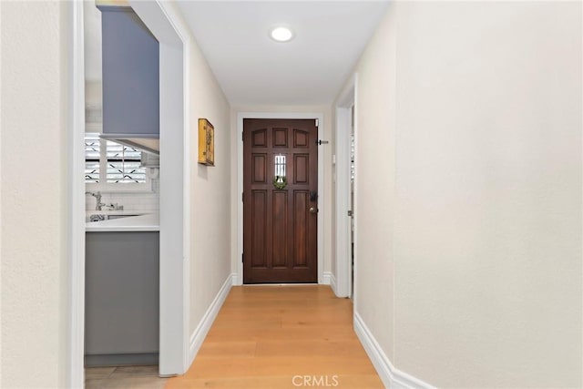 22941 Keswick St, West Hills, CA 91304 - doorway featuring light wood-style floors, baseboards, and recessed lighting