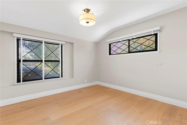 22941 Keswick St, West Hills, CA 91304 - spare room with light wood-style floors, plenty of natural light, vaulted ceiling, and baseboards