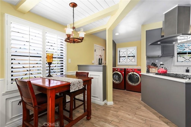 22941 Keswick St, West Hills, CA 91304 - dining area with washer and dryer, beamed ceiling, a chandelier, and light wood-style floors