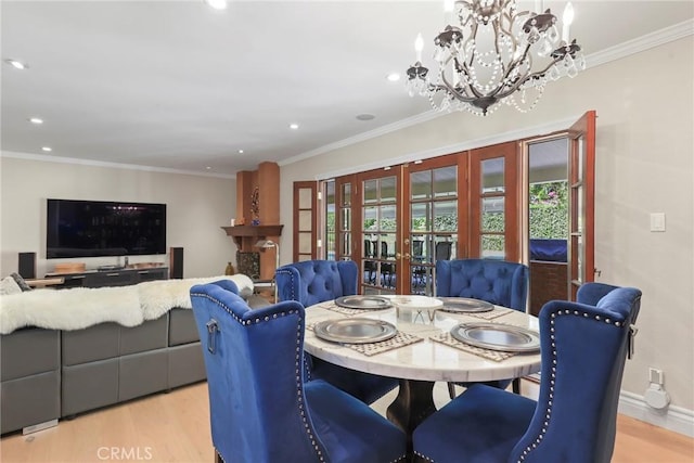 22941 Keswick St, West Hills, CA 91304 - dining area with french doors, light wood finished floors, a chandelier, recessed lighting, and ornamental molding