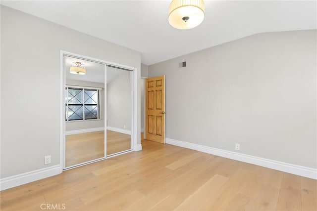 22941 Keswick St, West Hills, CA 91304 - unfurnished bedroom with wood finished floors, a closet, baseboards, and vaulted ceiling
