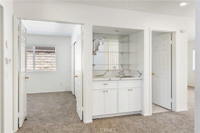 21965 Jeffers Ln, Saugus, CA 91350 - hallway with light carpet, a sink, and baseboards