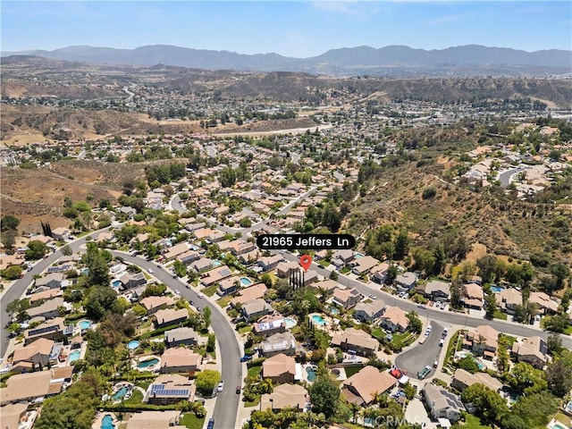 21965 Jeffers Ln, Saugus, CA 91350 - aerial view of property's location featuring a mountain backdrop and nearby suburban area