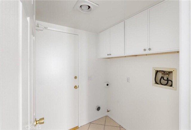 21965 Jeffers Ln, Saugus, CA 91350 - laundry room with cabinet space, light tile patterned floors, hookup for a washing machine, hookup for an electric dryer, and baseboards
